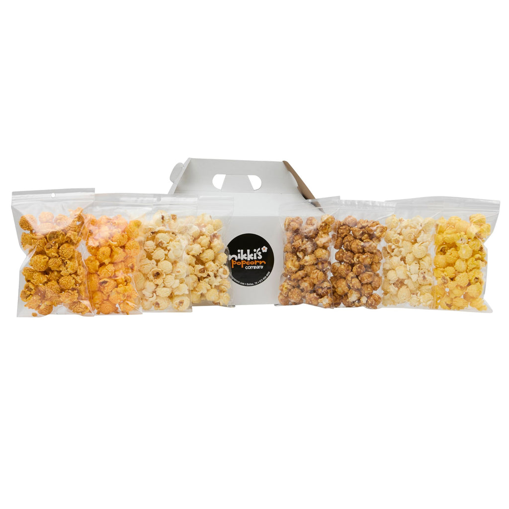 Packaged popcorn with five different flavors in a clear bag on a white background