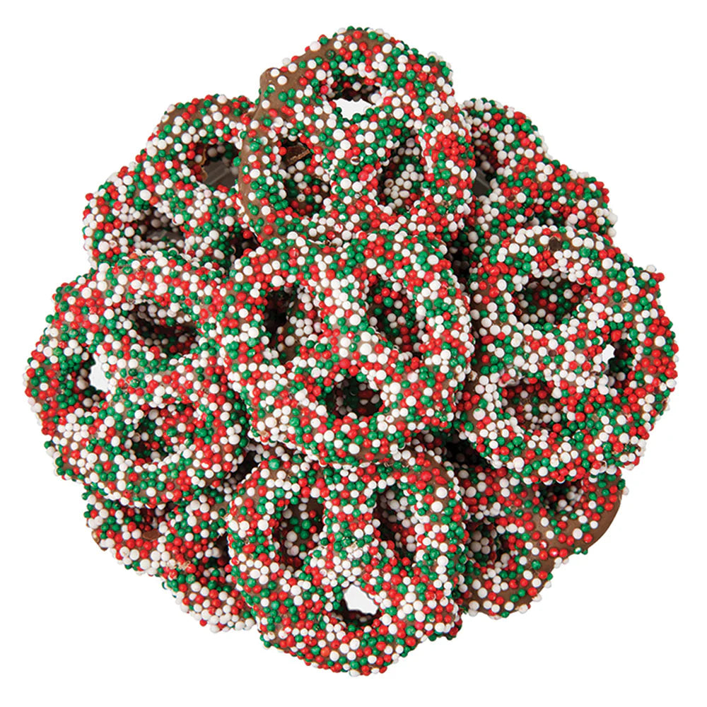 Decorative chocolate cvoered pretzels with red, green, and white beads on a white background