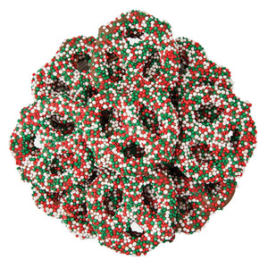 Decorative chocolate cvoered pretzels with red, green, and white beads on a white background